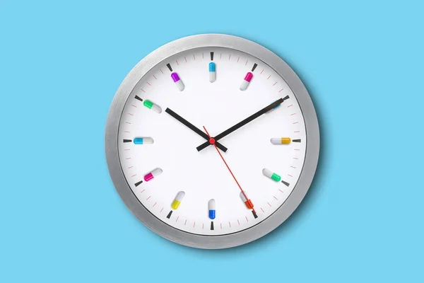 Wall clock with medicine capsules representing time by medication. On high pain days it can feel like your just living for the next time you can take another dose of pain medicine