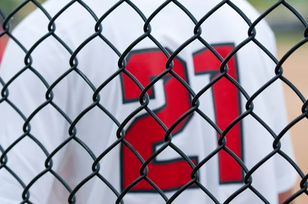 Close up of baseball fence with jersey — Stock Photo, Image