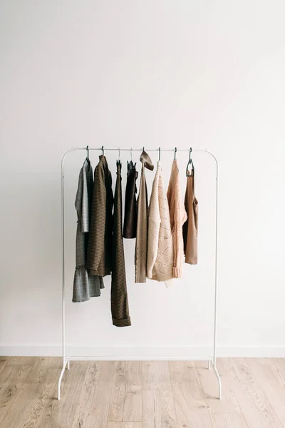 Rack with capsule clothes in beige colors — Stock Photo, Image