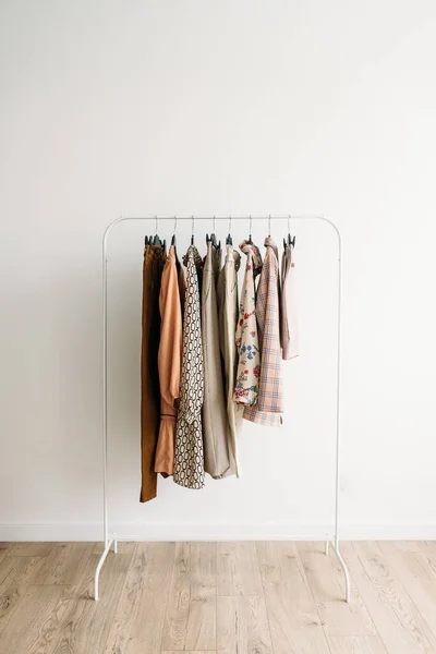 Rack with capsule clothes in beige colors — Stock Photo, Image