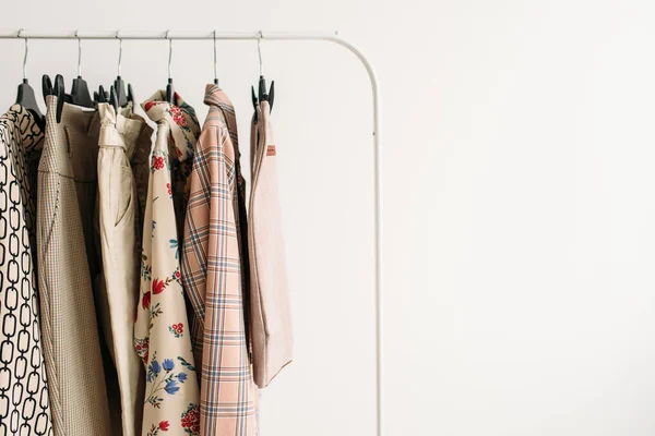 Rack with capsule clothes in beige colors closeup — Stock Photo, Image