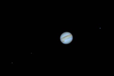 Planet Jupiter as seen from an advanced amateur telescope from a city sky at Santiago de Chile. Jupiter, the Giant Gas Planet show us its belts and spots like the great red spot, an awe night view clipart