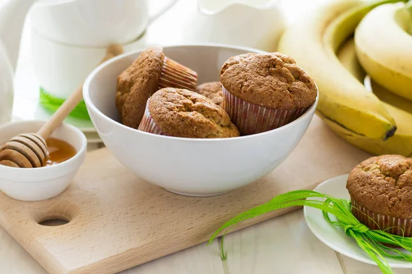 Tea time: homemade banana muffins, honey, bananas and tea settings — Stock Photo, Image