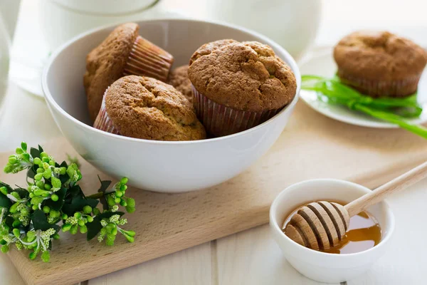 Tea time: homemade banana muffins, honey, bananas and tea settings — Stock Photo, Image