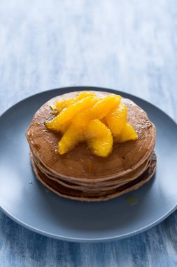 Geleneksel kahvaltı: yığın krep portakal dilimleri ve tatlı sos ile