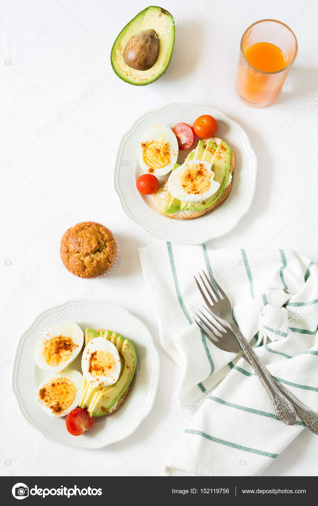 Healthy breakfast: toasts with avocado slices, tomato, paprika and eggs