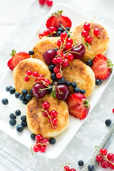 Hälsosam frukost: ost pannkakor med gräddfil och färska mogna bär — Stockfoto