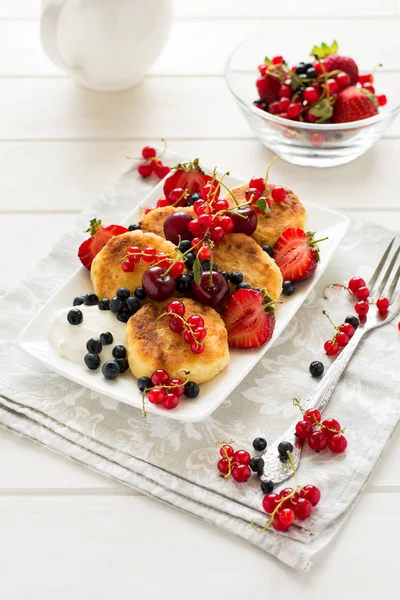 Hälsosam frukost: ost pannkakor med gräddfil och färska mogna bär — Stockfoto