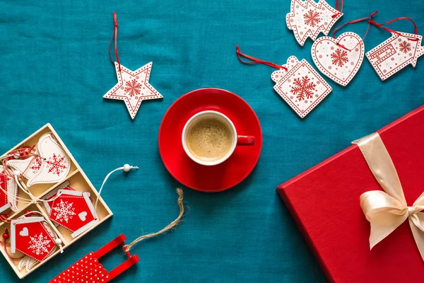 Preparing for Christmas. Red objects on turquoise background. Space for copy. Top view