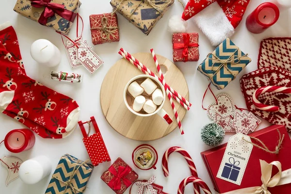 Christmas background with handmade presents wrapped in craft paper and  with cup of hot chocolate. — Stock Photo, Image