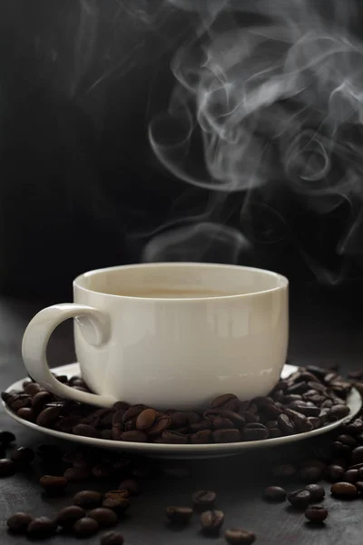 Hot cup of coffee with smoke on black background