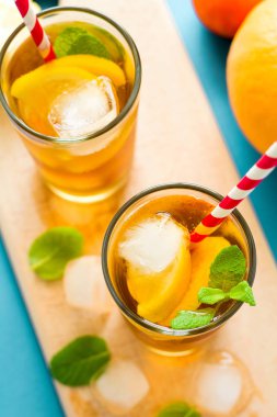 Limon dilimleri ve turkuaz ahşap zemin üzerine nane ile buzlu çay bardak