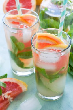 Ferahlık greyfurt nane nane kokteyli arka planını renklendirin. Sağlıklı narenciye yaz içeceği.