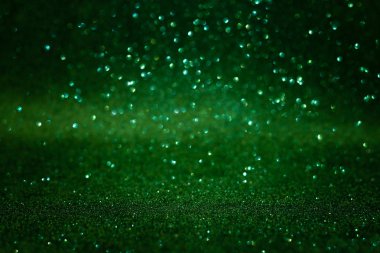 Green abstract glittering background. Defocused lights. Christmas greeting card. Christmas or New Year celebration concept. Copy space. Soft focus clipart