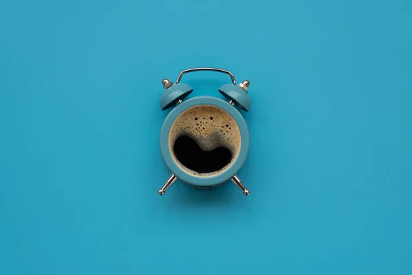 青い背景にコーヒーカップとして目覚まし時計 最上階だ平置きだおはようございます — ストック写真