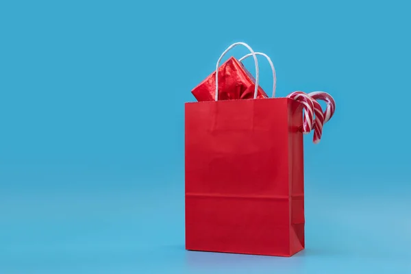 Red Papers Bag Gift Boxes Candy Sticks Blue Background Christmas — 图库照片