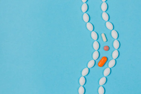 Mavi arka planda farklı haplar. Sağlık ve tıp. bağırsaklar