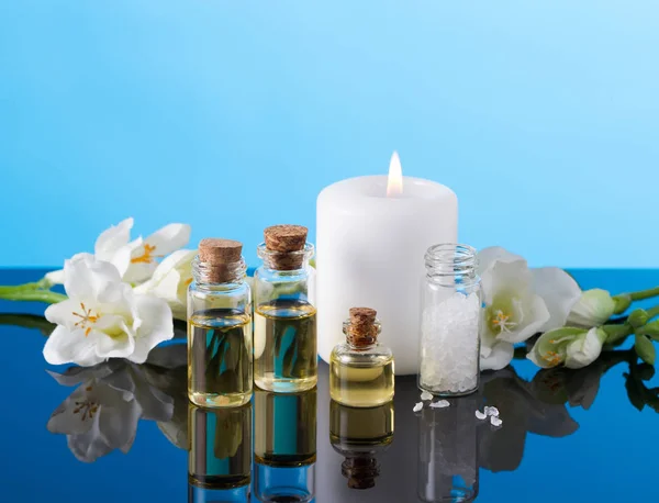 Ефірні олії ароматерапії, свічка, морська сіль та квіти — стокове фото