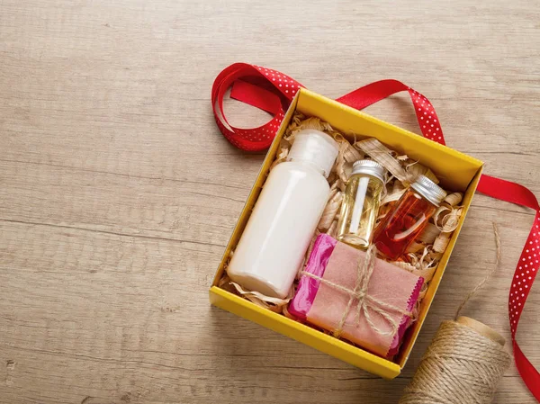 Cosmetics set in gift box. Body cream, essential oils, handmade soap