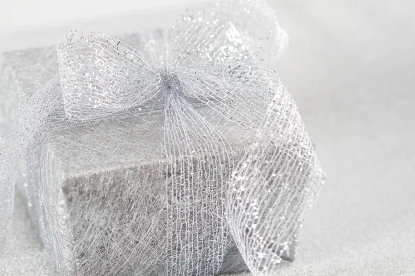 Silver gift box on silver glitter background — Stock Photo, Image
