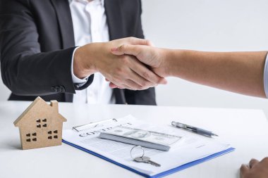 Image of successful deal of real estate, Broker and client shaki