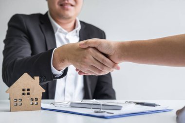 Image of successful deal of real estate, Broker and client shaki
