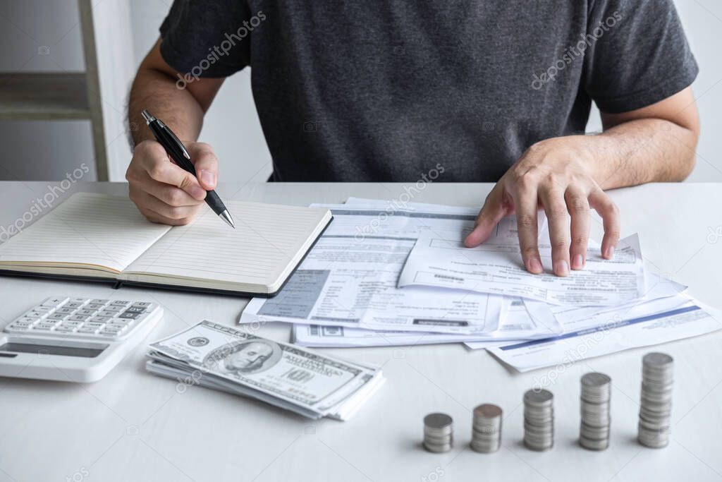 Images of stacking coin pile and Husband using calculator to calculating expenditure receipt bills of various activity cost and expenses in home office and written make report to plan of spent.