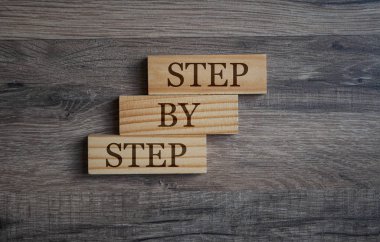 Cubes and dice with step by step on wooden background