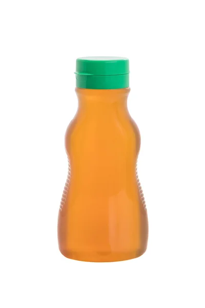 Мед в пластиковой бутылке — стоковое фото
