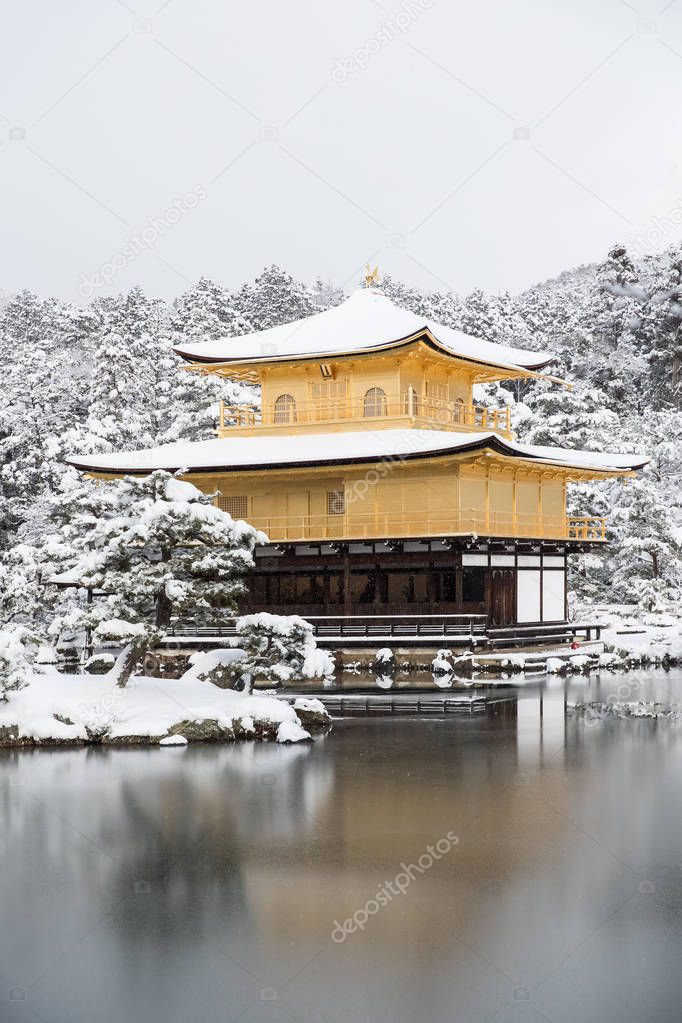 Zen temple Kinkakuji with snow fall