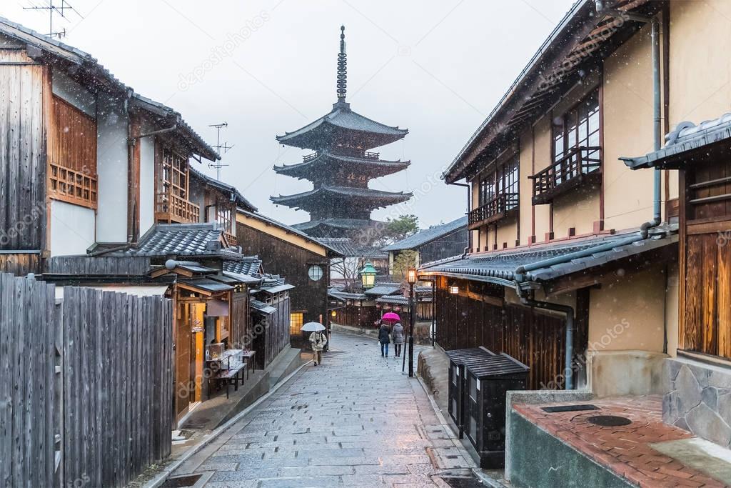 people on street near japanese pagoda 