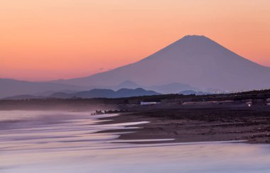 Mountain Fuji and sea wave in sunset at Southern Beach Chigasaki beach , Kanagawa prefecture , Japan clipart