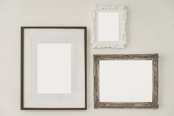 Vintage empty wooden frame on white concrete wall