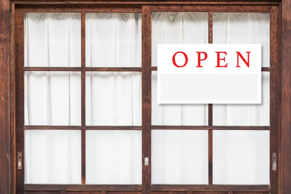 Open sign board on window of house