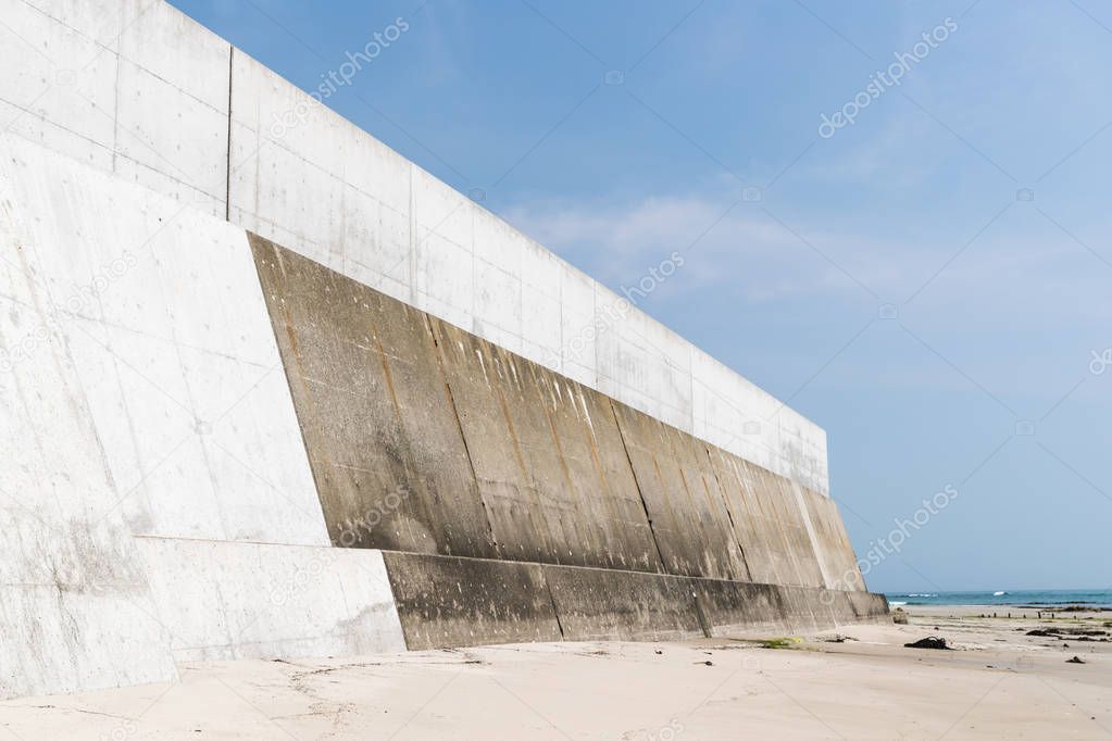 High concrete wall at seaside for protecting from tsunami big wave, Japan.