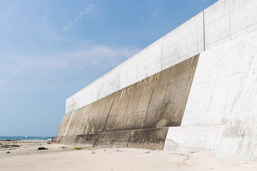 High concrete wall at seaside for protecting from tsunami big wave, Japan.