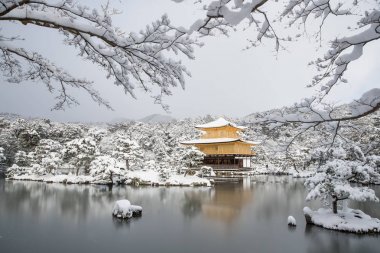 Zen temple Kinkakuji with snow fall in winter 2017 clipart