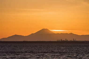 Mountain Fuji and Tokyo bay at sunset time in winter season.Tokyo Bay is a bay located in the southern Kanto region of Japan, and spans the coasts of Tokyo, Kanagawa Prefecture, and Chiba Prefecture. clipart