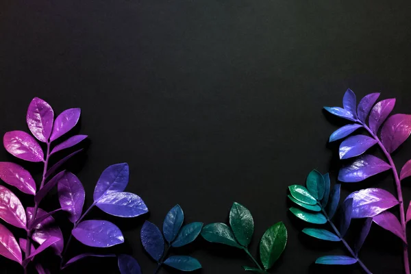 Creative fluorescent color layout made of tropical leaves with neon light square. Flat lay. Nature concept