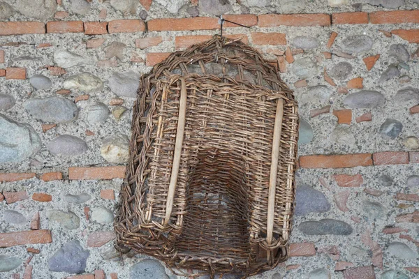 Old basket hanging on wall — Stock Photo, Image