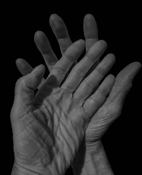 man\'s hands on black background