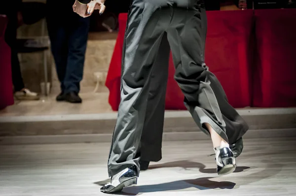 legs of a couple who dance in competition