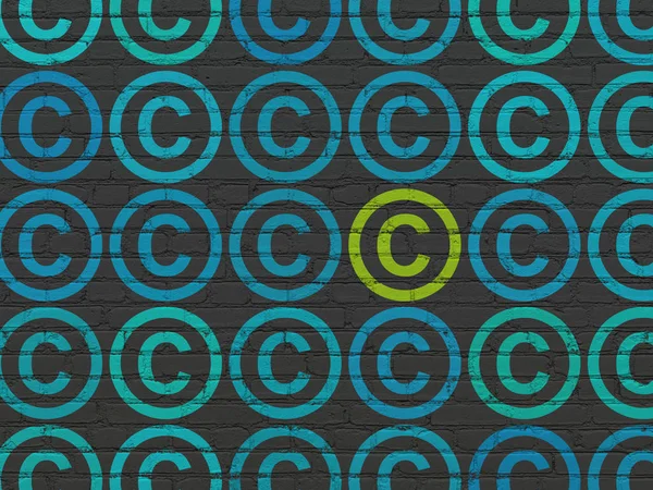 Law concept: rows of Painted blue copyright icons around green copyright icon on Black Brick wall background