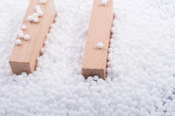 Houten Blokken Witte Polystyreen Schuimballen Als Achtergrond — Stockfoto