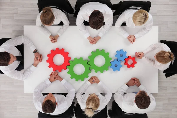 Conceptual Image Businessteam Working Cohesively Colorful Cogs Table Interaction Unity — Stock Photo, Image