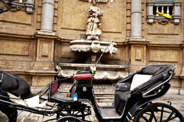 Buggy in the Quattro Canti, one of the octagonal four sides of Baroque square in Palermo - Italy clipart