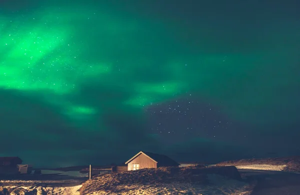 Beautiful view on the Aurora Borealis, amazing green light on the night sky, wonderful nature of Iceland