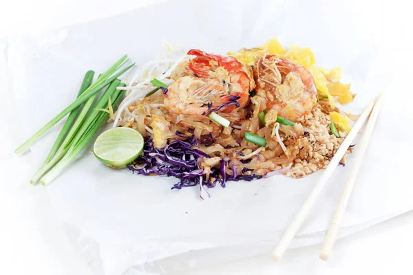 Fried noodle Thai style with prawns. Stir fry noodles with shrimp in (Pad Thai) Thai Cuisine on white color wrapper food.