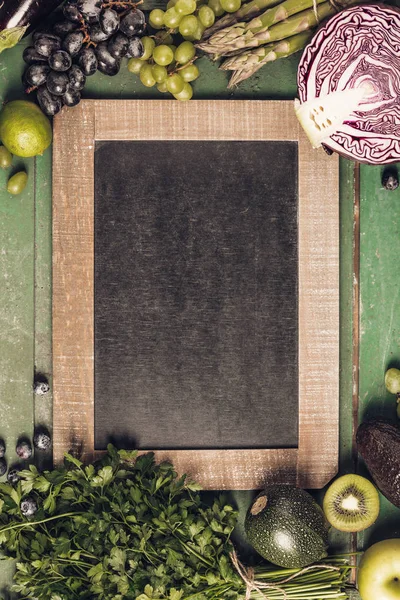 Assortment of raw organic fruits and vegetables: eggplants, onions, berries, carrots, grapes, cabbage, avocado, plums over rustic background, gluten free, allergy-friendly, clean eating or raw diet. Top view with space. Food frame — Stock Image Assortment Raw Organic Fruits Vegetables Eggplants Onions Berries Carrots Grapes Stock Image