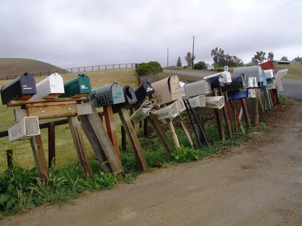 Row of old mail boxes on countryside road